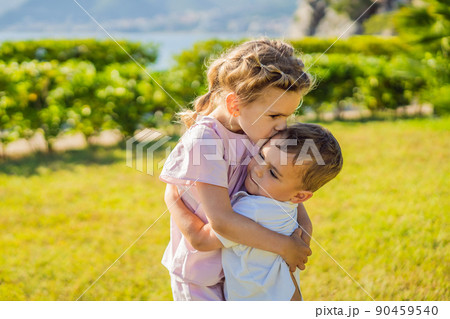 Portrait of two cute adorable baby children toddlers hugging and kissing each other, love friendship in childhood concept, best friends forever 90459540