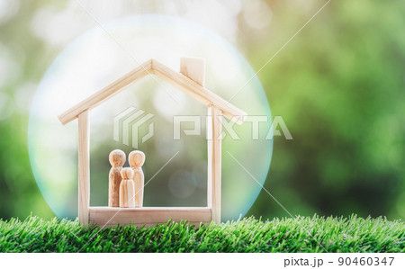 Wooden home with happy family of wooden doll is placed inside on nature bokeh. The saving money for house or real estate owner in the future concept. Wooden home with happy family of wooden doll is placed inside on nature bokeh. The saving money for house or real estate owner in the future concept. 90460347