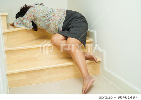 Asian lady woman injuries from falling down on slippery surfaces stairs at home. Asian lady woman injuries from falling down on slippery surfaces stairs at home. 90461497