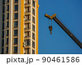 Crane with building in the background, blue skys 90461586