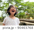 Cute little girl is laughing in the garden 90463768