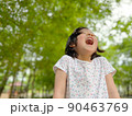 Cute little girl is laughing in the garden 90463769
