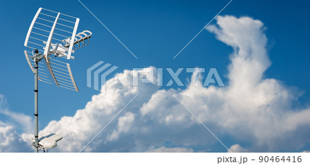 Directional Television Antenna against a Clear Blue Sky and Clouds Directional Television Antenna against a Clear Blue Sky and Clouds 90464416