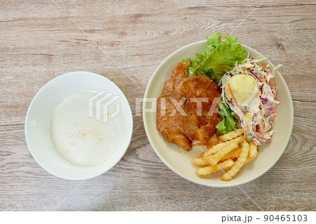 grilled pork steak dressing barbecue sauce with mashed potato and salad on plate couple corn soup in bowl 90465103