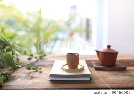 Wooden tea cup and tea pot on wooden table 90466009
