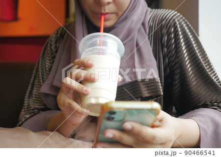 young women drinking banana milk shake at cafe young women drinking banana milk shake at cafe 90466541