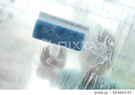 Close up of man hand cleaning window glass Close up of man hand cleaning window glass 90466545