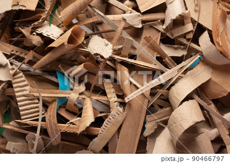 Waste paper as background texture. Recycling brown cardboard heap 90466797