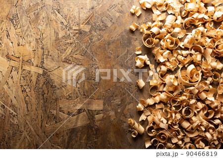 Wood shavings on table background. Wooden shaving at old plank board 90466819