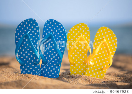 Beach flip-flops on the sand 90467928