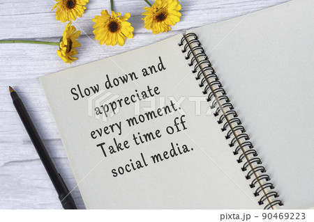 Motivational quote on note book with sunflowers on wooden desk. 90469223