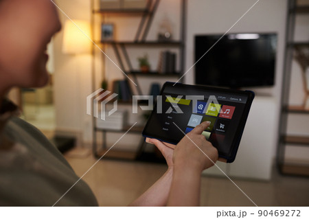 Woman Turning on Smart TV Application 90469272