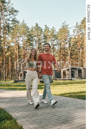 Romantic couple enjoying their stroll in the recreation area Romantic couple enjoying their stroll in the recreation area 90469736