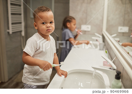 Little Boy Brushing Teeth in Bathroom Little Boy Brushing Teeth in Bathroom 90469966