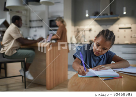 Girl Doing Homework in Kitchen 90469993