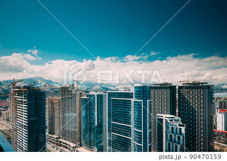 New Residential Multi-storey Houses On Blue Sky. Real Estate, Development Industry. highrise houses Elevated View Cityscape Skyline. Light Lighting. Industrial concept. Building industry 90470159
