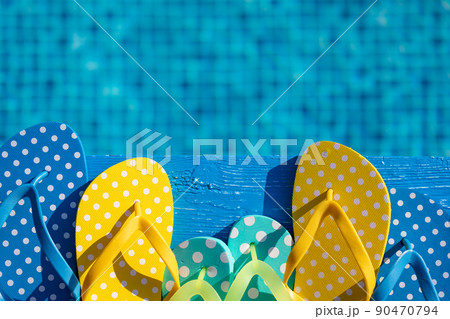 Beach flip-flops on blue wooden background Beach flip-flops on blue wooden background 90470794