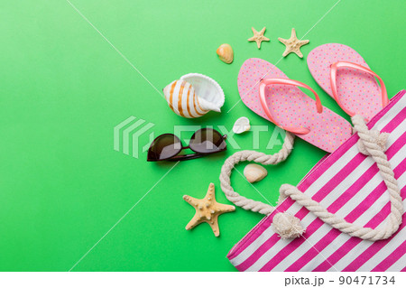beach accessories flat lay top view on colored background Summer travel concept. Bag with starfish and sea shell. Top view 90471734