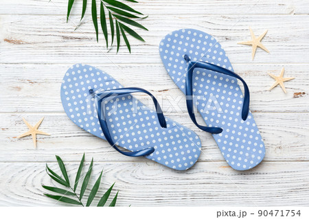 Flat lay composition with flip flops and seashell on colored background. Space for text top view Flat lay composition with flip flops and seashell on colored background. Space for text top view 90471754