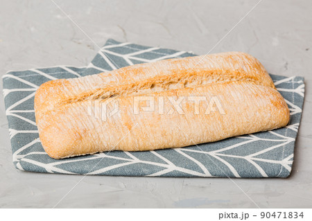Assortment of freshly baked bread with napkin on rustic table top view. Healthy unleavened bread. French bread 90471834
