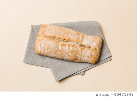 Fresh ciabatta bread on napkin on rustic background, Italian bread top view Fresh ciabatta bread on napkin on rustic background, Italian bread top view 90471845