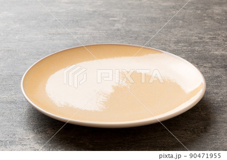 Perspective view of empty light plate on cement background. Empty space for your design 90471955