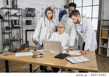 Interns having meeting with senior doctor in hospital office Interns having meeting with senior doctor in hospital office 90473685