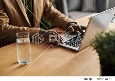 Hands of young male counselor touching keys of laptop keyboard at work 90473871