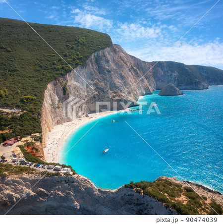 Aerial view of blue sea, rock, sandy beach at sunset in summer Aerial view of blue sea, rock, sandy beach at sunset in summer 90474039