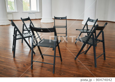 Part of lecture hall or spacious auditorium with group of chairs forming circle 90474042
