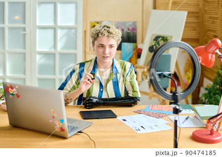 Young confident female blogger giving masterclass to online audience 90474185