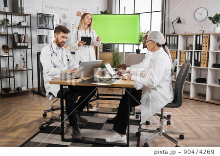 Medical experts using monitor with mock up screen on meeting 90474269