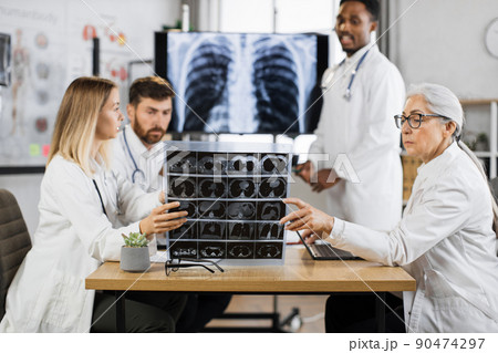 International doctors examining xray scan of lungs and brain International doctors examining xray scan of lungs and brain 90474297