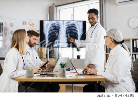 Multiracial doctors having meeting about patient diagnosis Multiracial doctors having meeting about patient diagnosis 90474299