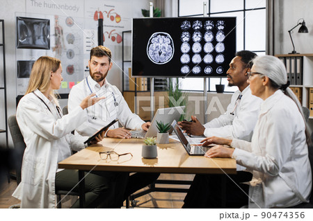 Medical team having meeting in conference room in hospital 90474356