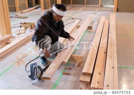 木造住宅の現場で木材の加工をする大工 90475753