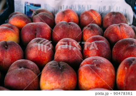 Bright juicy red peaches on a farmer's market stall Bright juicy red peaches on a farmer's market stall 90478361