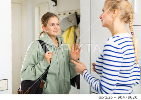 Daughter saying goodbye mom in entrance hall of apartment Daughter saying goodbye mom in entrance hall of apartment 90478620