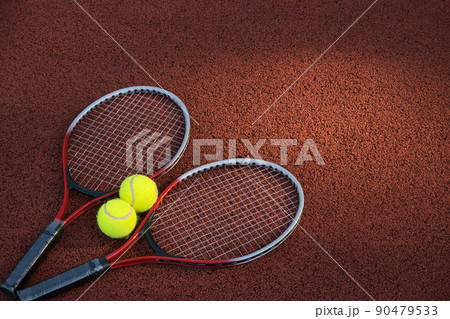 Tennis ball, racquet on hard court surface 90479533