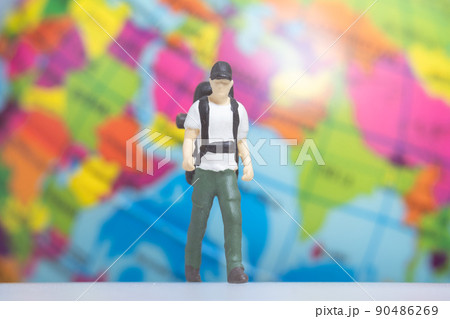 Miniature People Traveler with backpack on The Globe background Miniature People Traveler with backpack on The Globe background 90486269