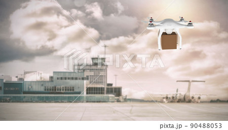 Drone carrying a box in an airport 90488053