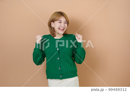 Young beautiful girl very happy and excited doing winner gesture with arms raised, smiling and screaming for success. celebration concept. Young beautiful girl very happy and excited doing winner gesture with arms raised, smiling and screaming for success. celebration concept. 90489312