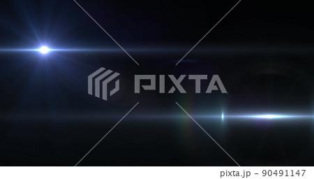 Image of two beams of white light moving across dark background 90491147