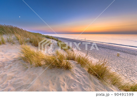 Sunset View over ocean from dune in Zeeland Sunset View over ocean from dune in Zeeland 90491599