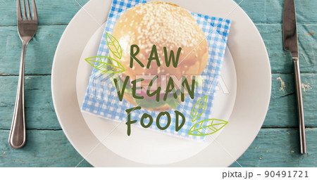 Image of raw vegan food text over fresh hamburger Image of raw vegan food text over fresh hamburger 90491721