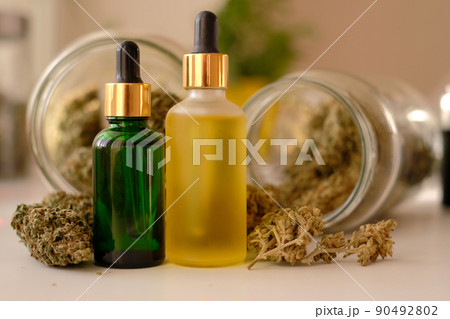 CBD oil on background with dry cannabis buds. Marihuana extract. CBD oil on background with dry cannabis buds. Marihuana extract. 90492802