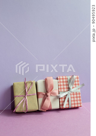 Gift boxes on purple table. purple wall background. copy space Gift boxes on purple table. purple wall background. copy space 90495923
