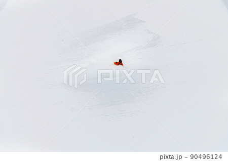 one freeride skier skiing downhill trough deep fresh powder 90496124