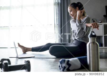 Asian woman exercising at home Asian woman exercising at home 90496952