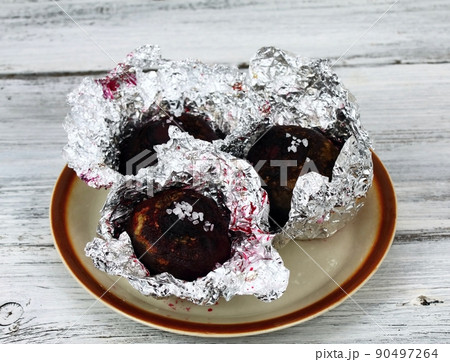 Baked red beet removed from the oven 90497264